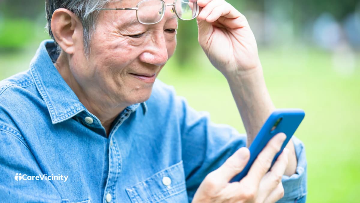Older man checking information on his phone outdoors